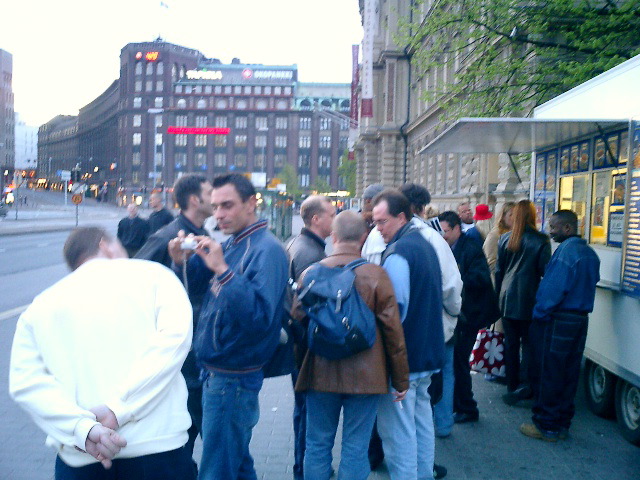 standing in a row to have some food at 4am